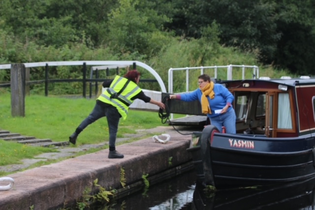 Volunteer lock keeper assisting boater